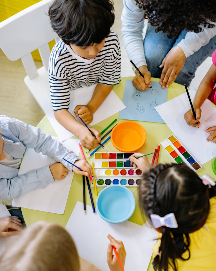 Young children using watercolour to paint